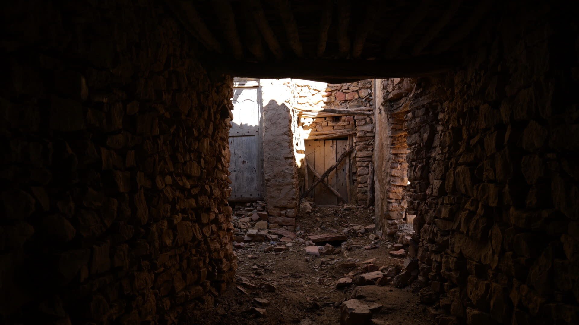 Dark stone corridor with light at the end