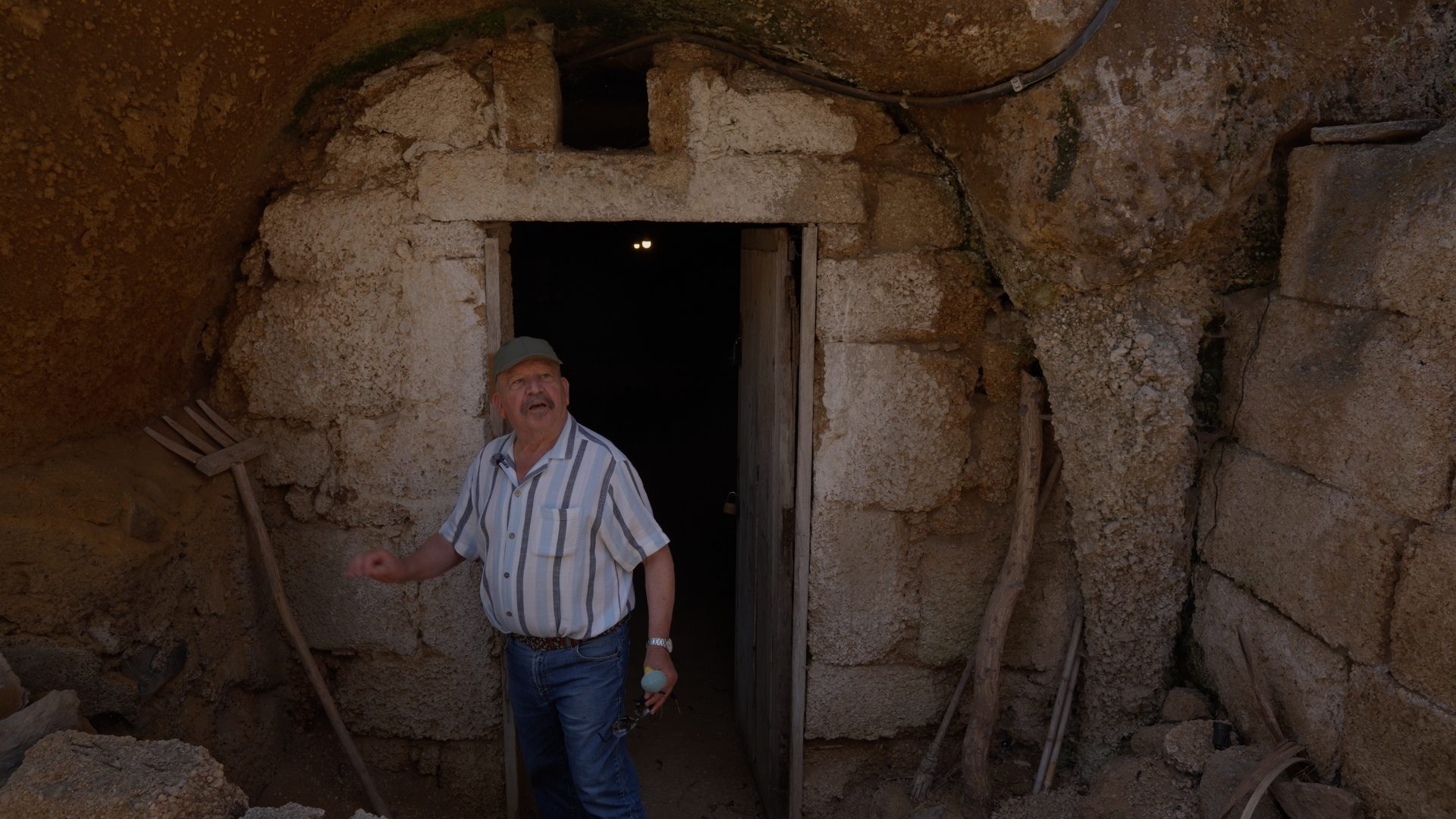 A man at the stone doorway of an old building in Icor