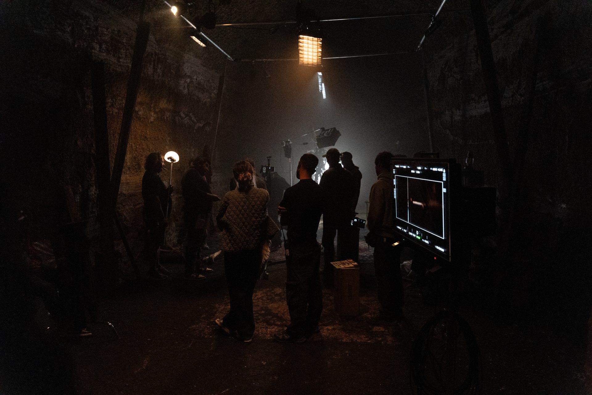 Night scene on the set of The Silenced, crew and lights in a dark interior